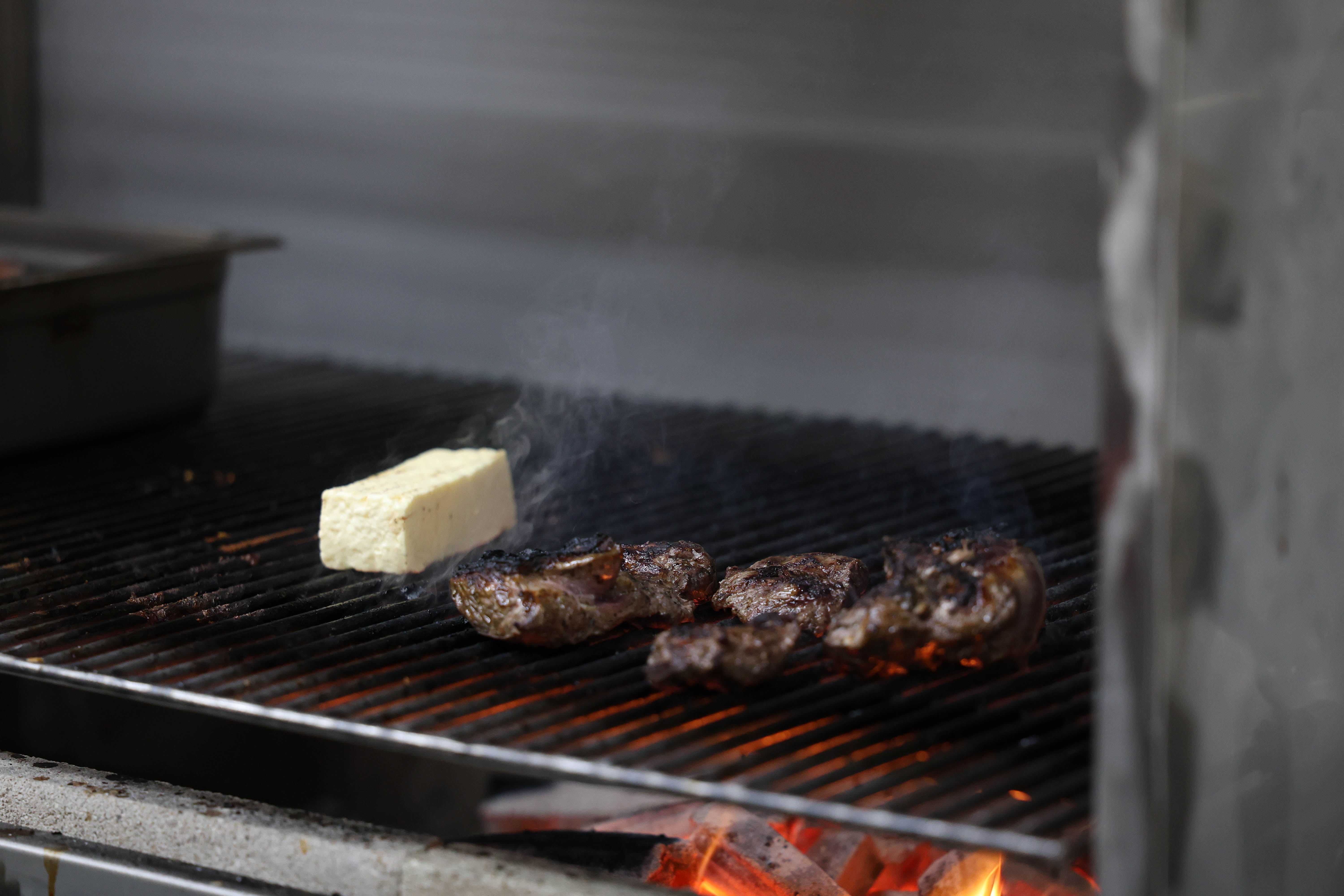 Picanha searing over live charcoal at Kika's Kitchen